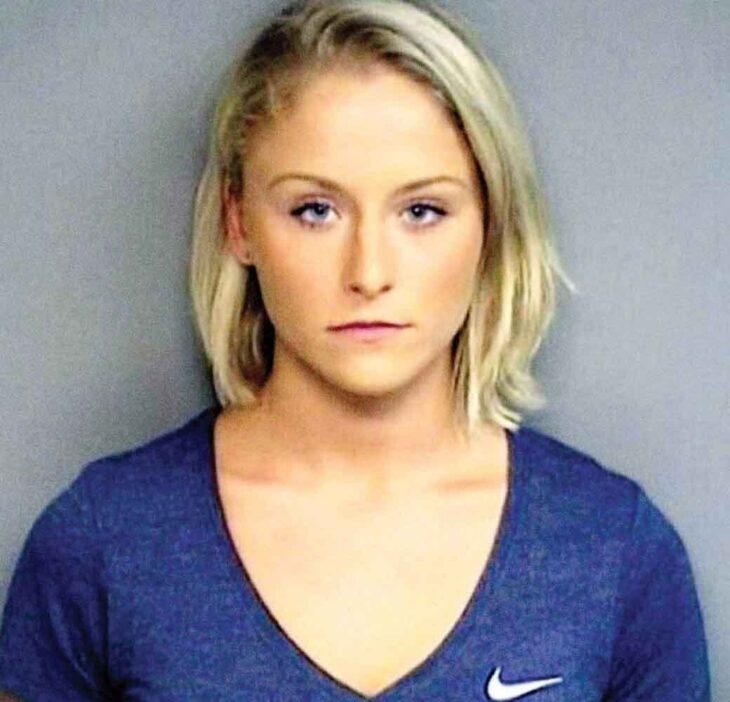 mugshot of an attractive female with short straight blonde hair