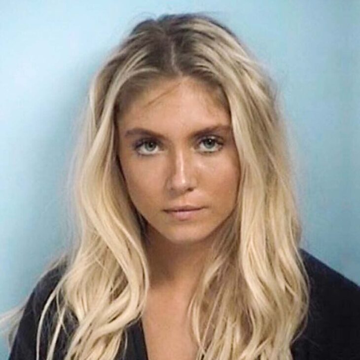 a mugshot of a blonde woman with an attracive face
