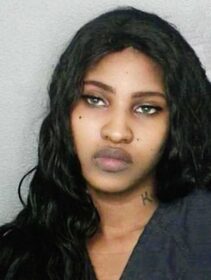 a police photo of an attractive dark haired woman