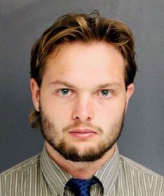 a well dressed and good looking guy mugshot
