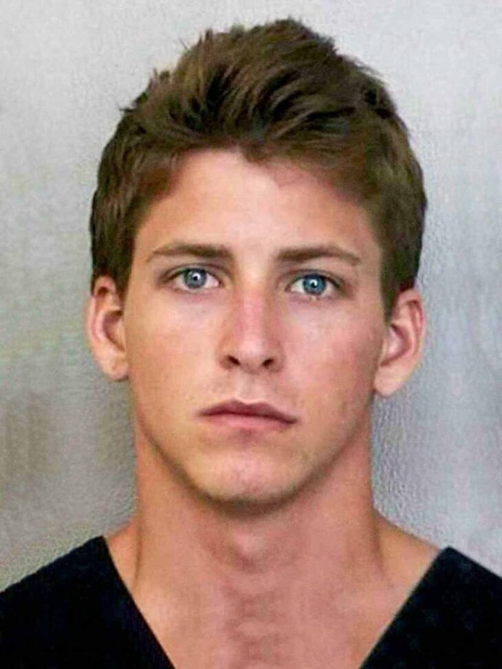 mugshot of a handsome short haired guy with deep blue eyes