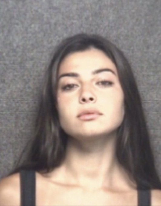 mugshot of an attractive woman looking like a fashion model