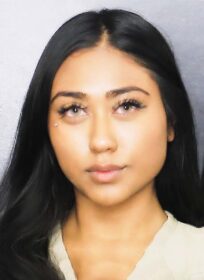 mugshot of a very hot looking woman with beautiful pale green eyes and long dark hair