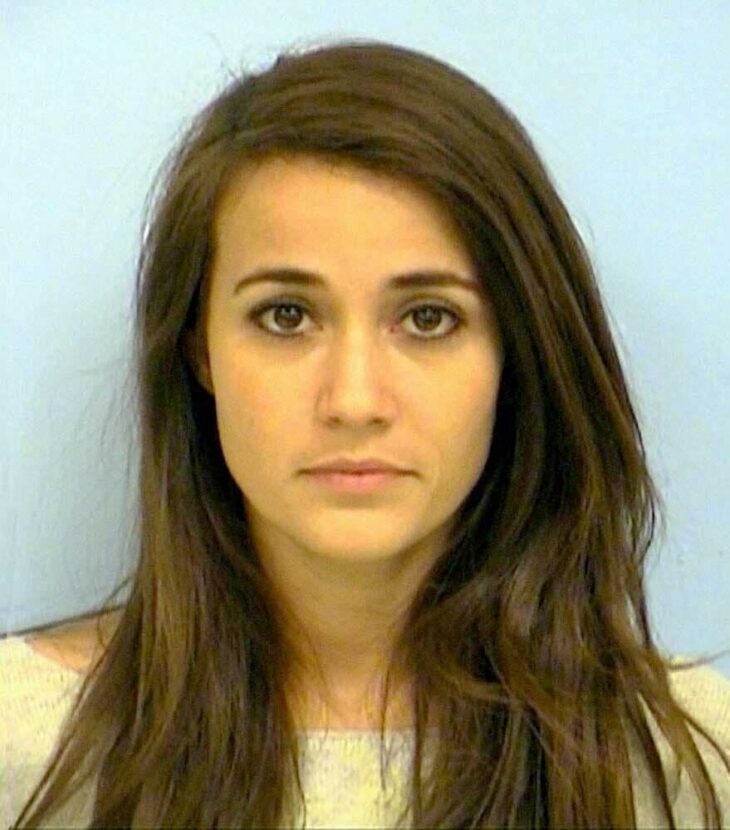 a police picture of a woman with a very pretty face and long brown hair